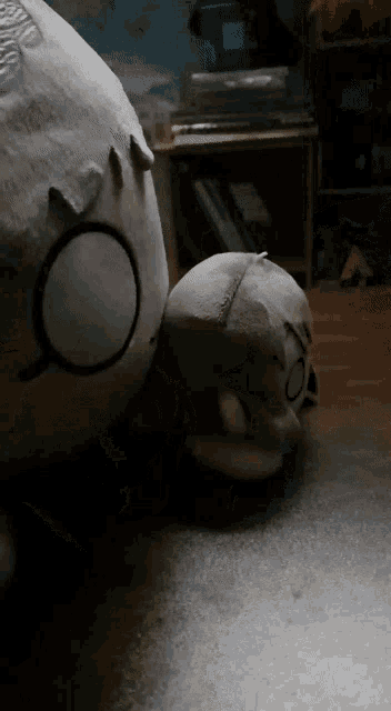 a stuffed animal with a magnifying glass on it is laying on the floor