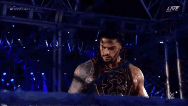 roman reigns is a wrestler with long hair and a beard and is crying .