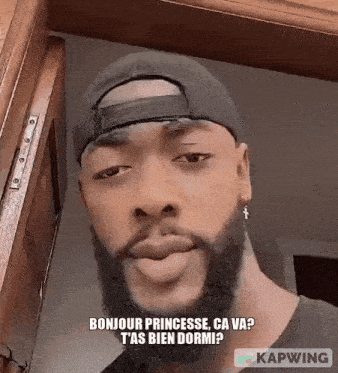 a man with a beard wearing a baseball cap and earrings says bonjour princesse ca va ?