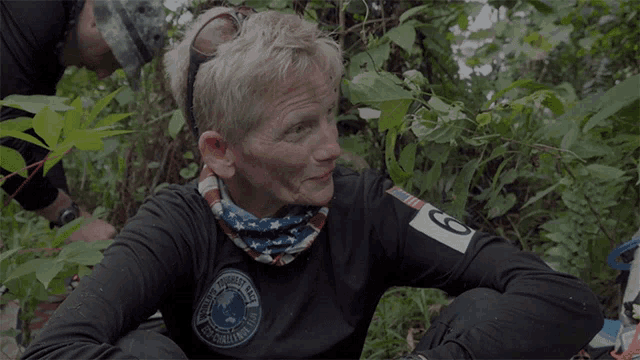 a woman wearing a black shirt with a patch that says national guard on it