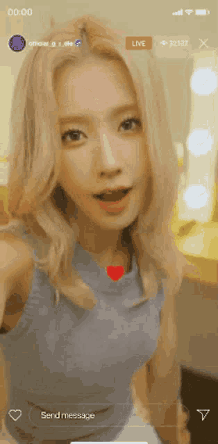 a woman is taking a selfie on a cell phone with the time of 00:00