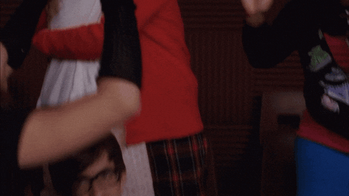 a man in a hat is hugging a woman in a white sweater