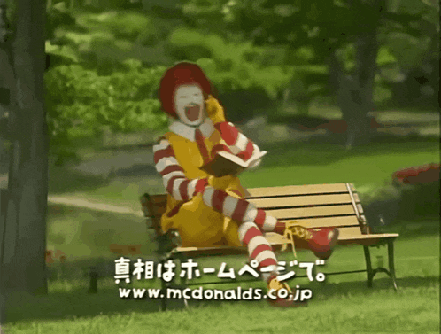 a mcdonald 's advertisement shows mr. donald sitting on a bench reading a book