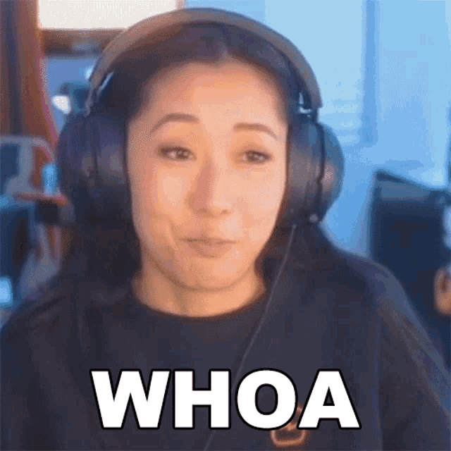 a woman wearing headphones is making a face and saying whoa