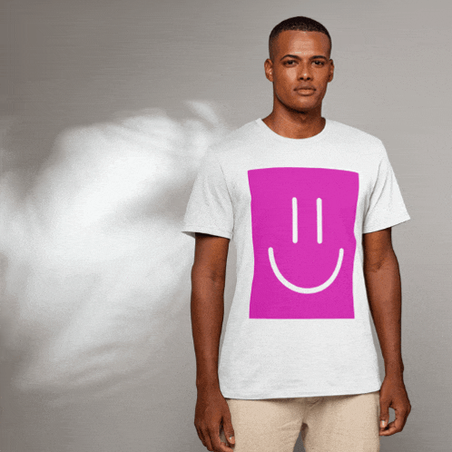 a man wearing a white t-shirt with a pink square with a smiley face on it