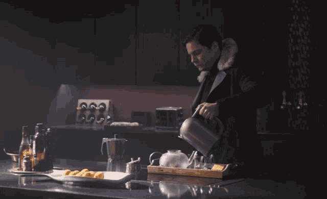 a man in a fur coat is pouring tea into a cup