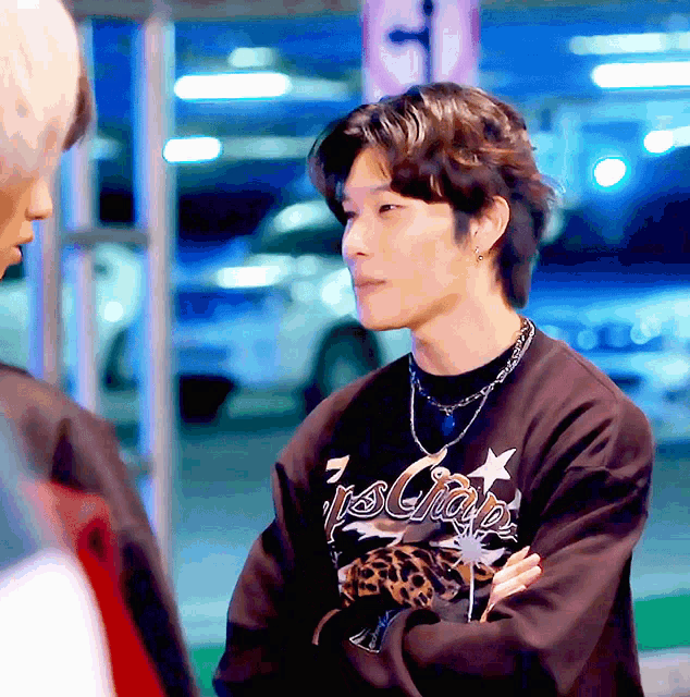 a man wearing a sweatshirt that says ' 7 's chap ' on it