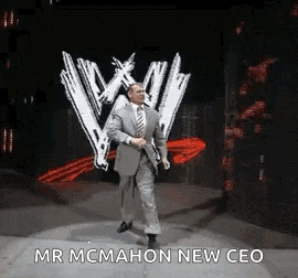 a man in a suit and tie is walking on a stage .
