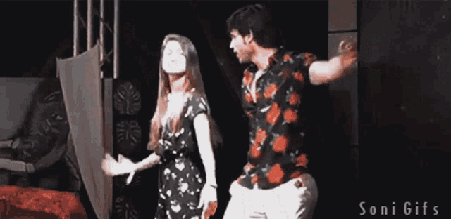 a man and a woman are dancing on a stage with the words soni gifs visible in the corner