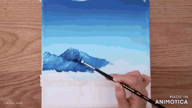 a person is painting a mountain with a brush and the words made in animotica are visible