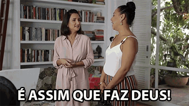 two women standing next to each other in a living room with the words e assim que faz deus