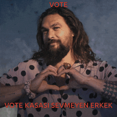 a man with long hair and a beard is wearing a polka dot shirt