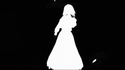 a silhouette of a girl in a white dress surrounded by petals