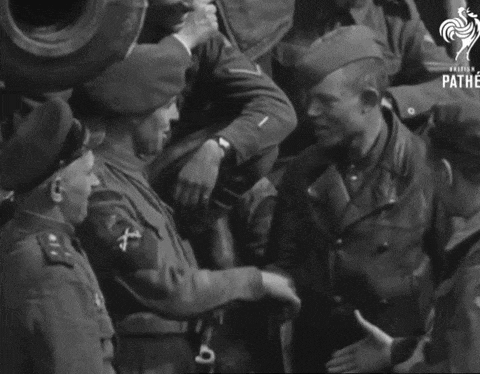 a group of soldiers are shaking hands and the word pathe is on the bottom