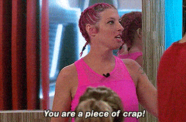 a woman with pink hair is standing in front of a mirror and saying you are a piece of crap