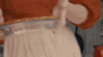 a close up of a person holding a tray of food in their hands .