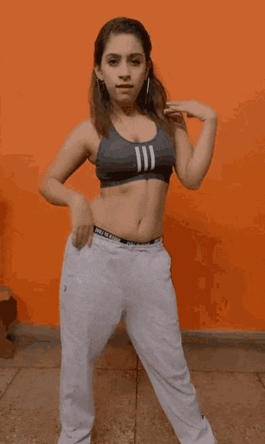 a woman wearing a crop top that says ii on it