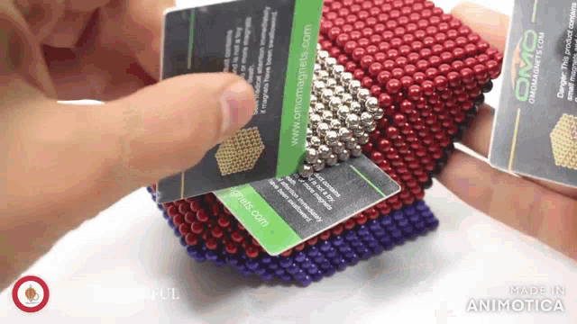someone is holding a card that says omamagnets.com