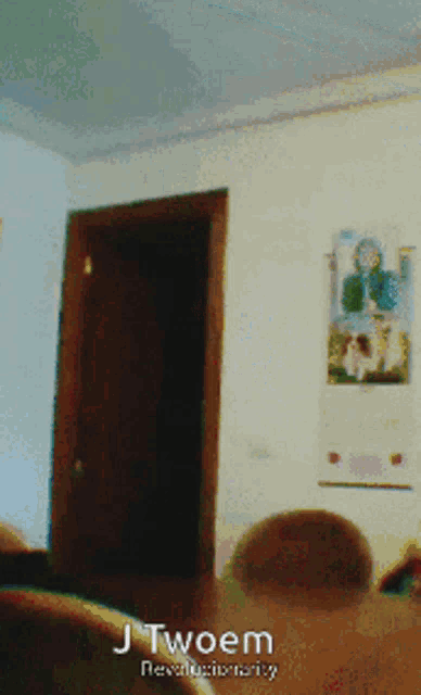 a room with a door and a picture on the wall that says j twoem revolutionary