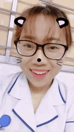 a woman wearing glasses and a cat face mask smiles