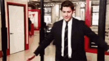a man in a suit and tie is standing in front of a security check .