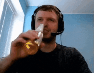 a man wearing a headset is drinking from a bottle