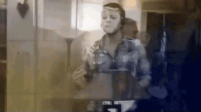 a man wearing headphones and a mask is playing drums
