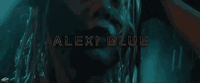 a woman in a dark room with the words alexi blue written in orange