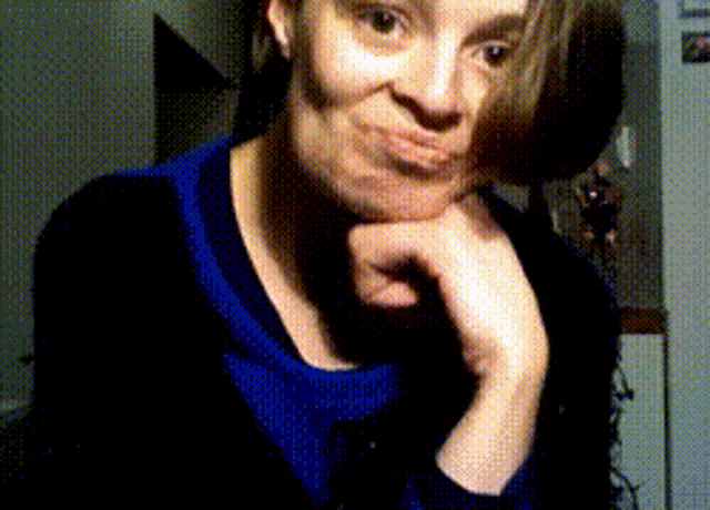 a woman with her hand on her chin makes a funny face