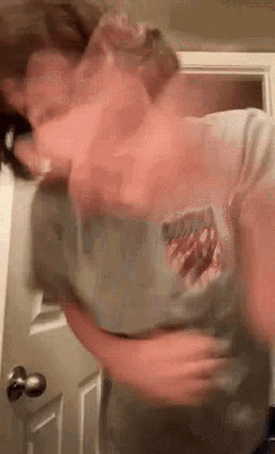 a blurry picture of a person wearing a t-shirt that says ' eagles ' on it .