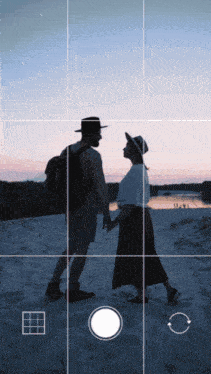 a man and a woman are standing in the sand and looking at each other