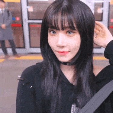 a girl with a choker around her neck is smiling