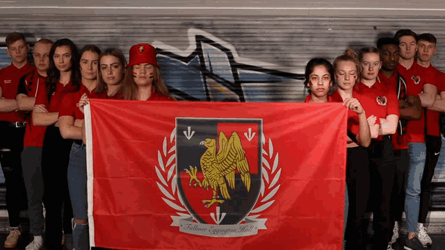 a group of people holding a red flag that says " fulton simpson hill "