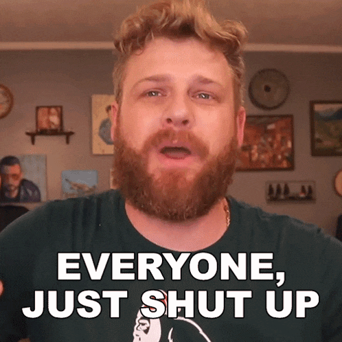 a man with a beard and a green shirt says everyone just shut up