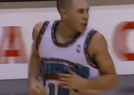 a basketball player wearing a jersey that says t on it