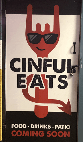 a sign that says ' cinful eats ' on it with a devil on it