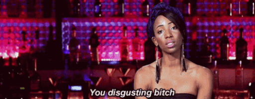 a woman in a black dress is standing in front of a bar and says `` you disgusting bitch '' .