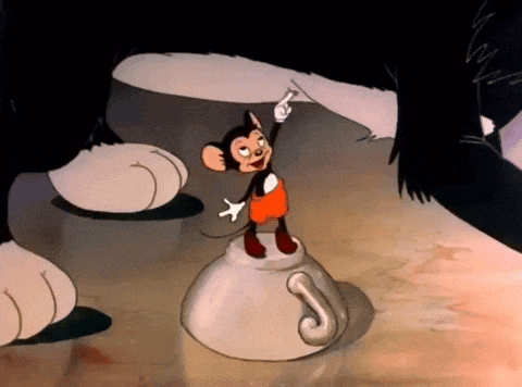 a cartoon mouse is standing on top of a small cup