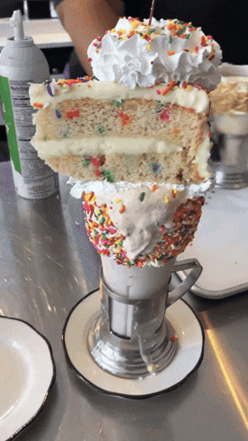 a milkshake with a slice of cake and sprinkles on top