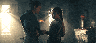 a man and a woman are holding hands in a room