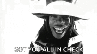 a black and white photo of a woman wearing a hat and smiling with the words `` got you all in check '' .