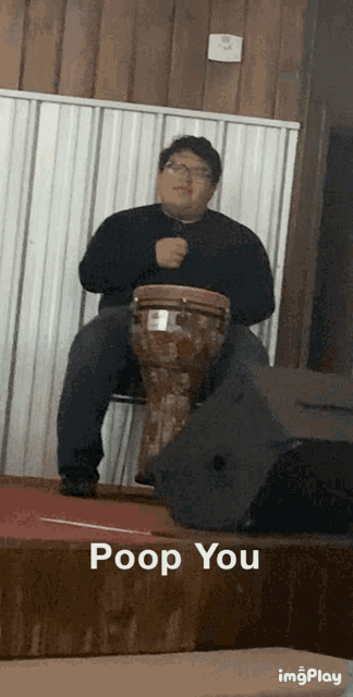 a man is playing a drum with the words poop you below him