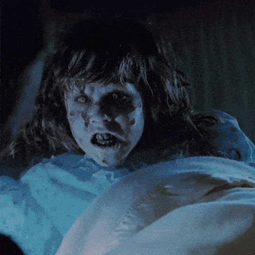 a close up of a person 's face with a blue light behind them