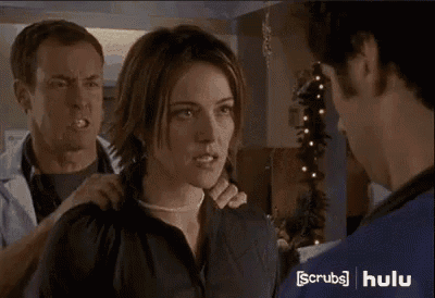 a woman in a black shirt is talking to a man in a white coat .