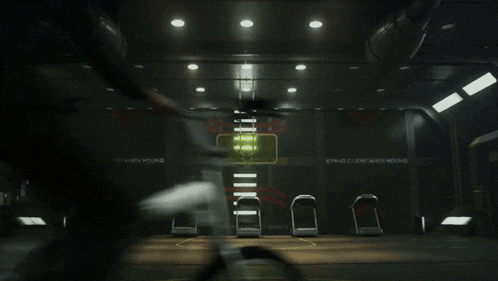 a man sits in a dark room with a sign on the wall that says cnc cutting machine room