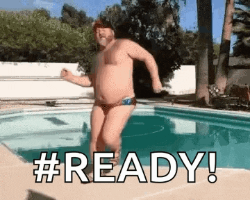 a man in a bikini is jumping into a swimming pool .