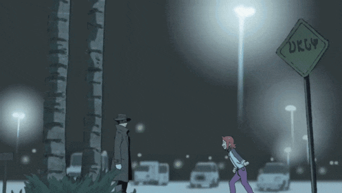 a man in a hat watches a girl in a red hat run in the dark