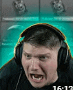 a man wearing headphones is making a funny face while playing a video game .