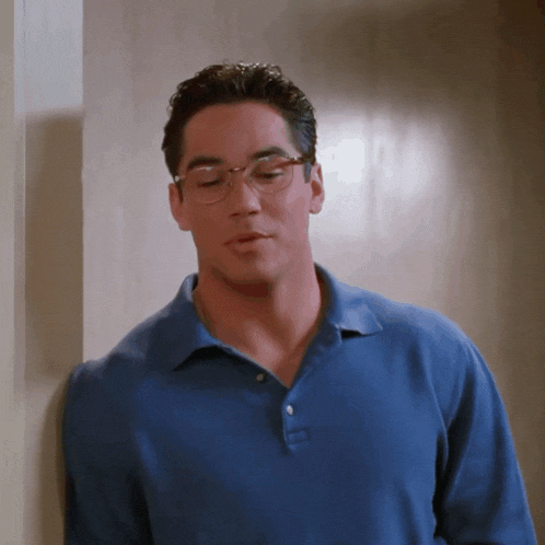 a man wearing glasses and a blue polo shirt