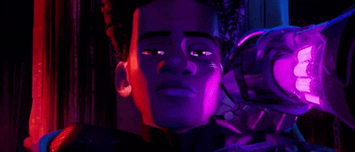 a close up of a person 's face in a dark room with purple lights .